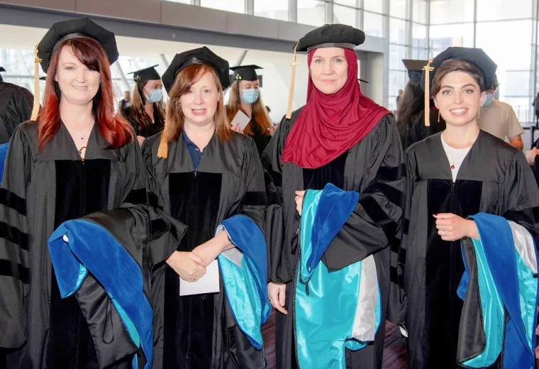 Dr. Dawn Wawersik, Dr. Maura Polansky, Dr. Cynthia Mosher, and Dr. Alex Morton are the first four graduates of the PhD in Health Professions Education program.at 2022 Commencement.