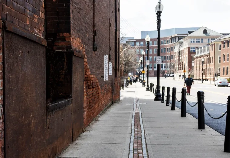 sidewalk with brick path down the center of it