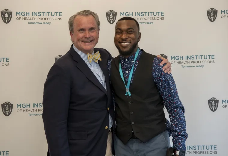 Dean White (left) and Ian Syblis pose in front of an IHP background