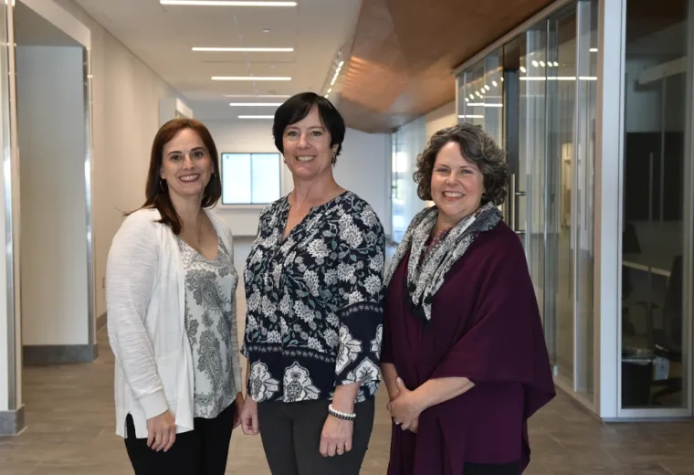Picture of Lisa Moran, Barbara Wilson Arboleda, and Jenn Mackey standing together at IHP