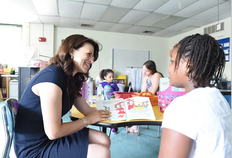 Photo of Dr. Joanna Christodoulou with child at the Harvard Kent School