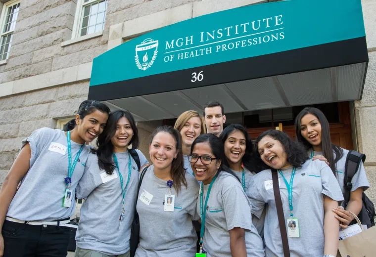group of female and one male student smile for the camera in matching shirts
