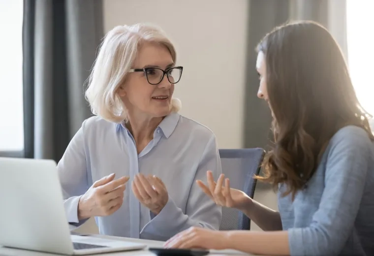 an older and younger woman converse