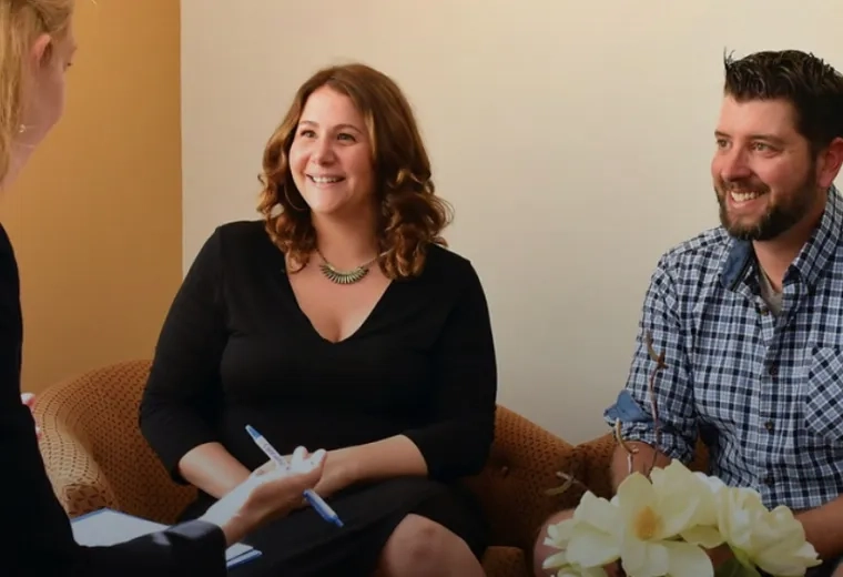 Two people speaking with a genetic counselor 