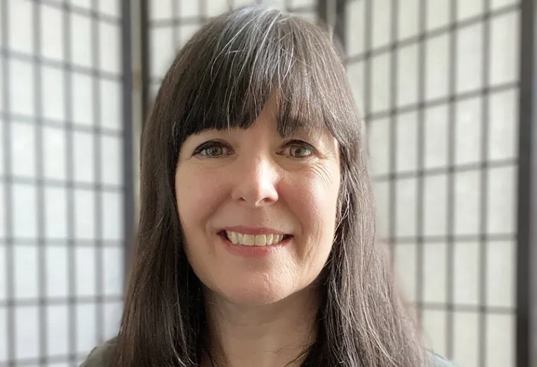 jessica has shoulder length straight brown hair and wears a black button cardigan