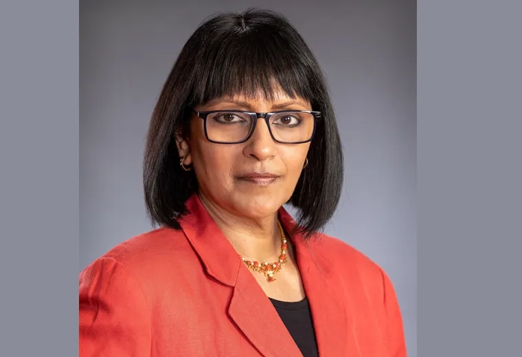 subha wears black rimmed glasses and a red blazer