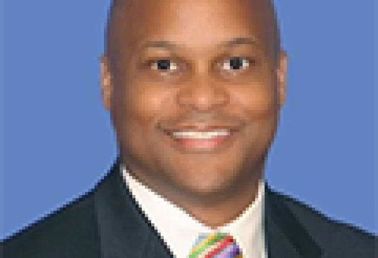 thaddeus wears a dark suit and a colorful tie