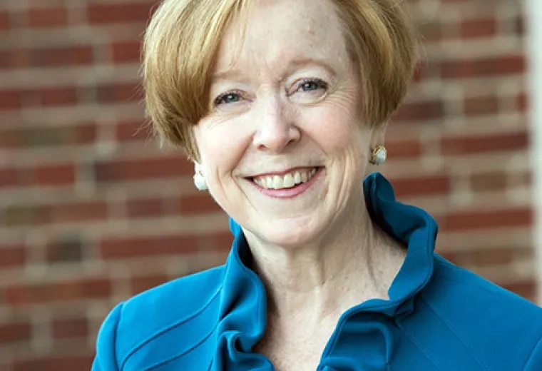 debbie wears a royal blue top with a ruffle