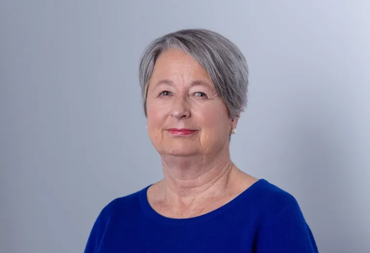 Rita Olans in blue shirt