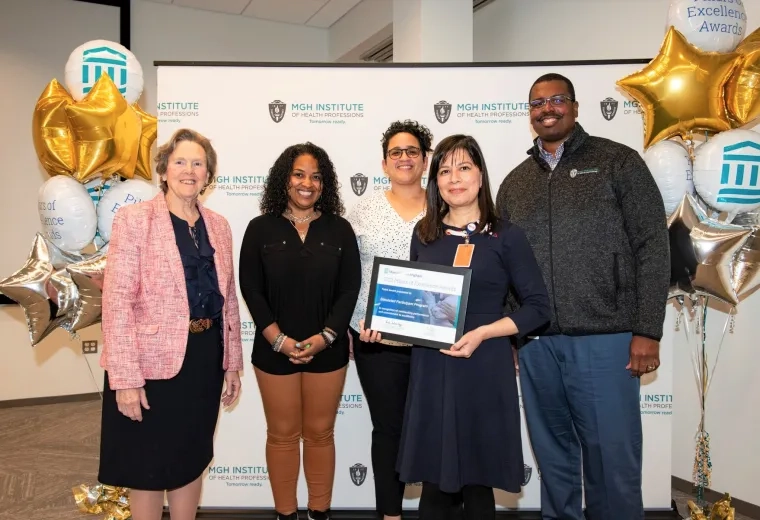 group stands next to balloons