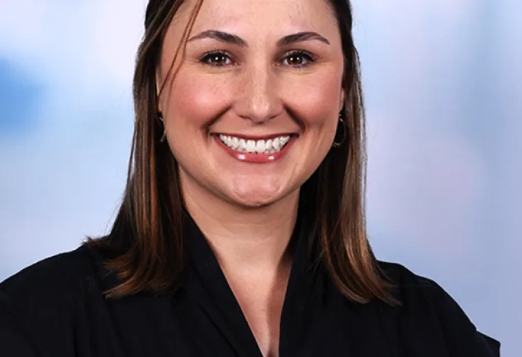 karen has a big smile and wears a black cap sleeve top