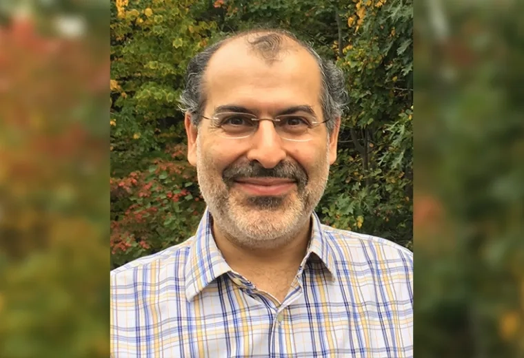 photo of pedram in front of fall foliage