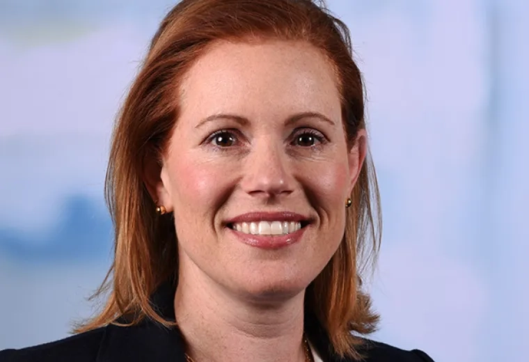 allison has red hair and wears a black blazer