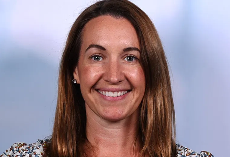 jenna has a flowered top and honey brown hair