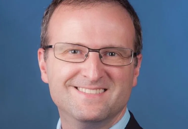 daniel wears rectangular glasses in this profile shot