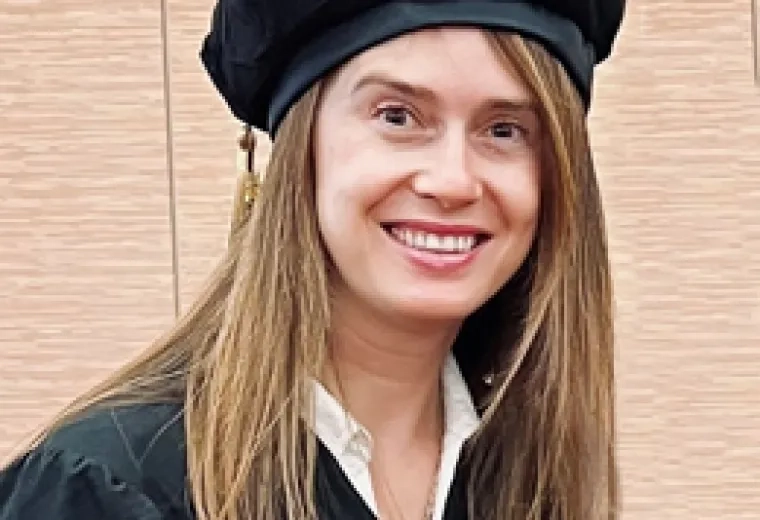 woman in cap and gown smiling