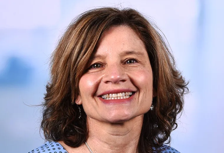 trish has a big smile and light brown hair in a bob cut