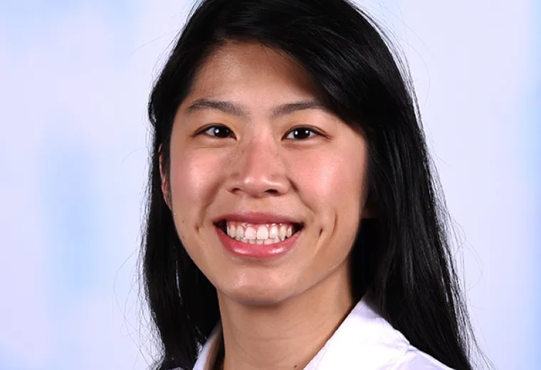 abby has straight black hair and a white collared shirt