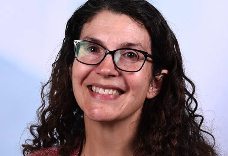 jessica has black rimmed glasses and long curly black hair