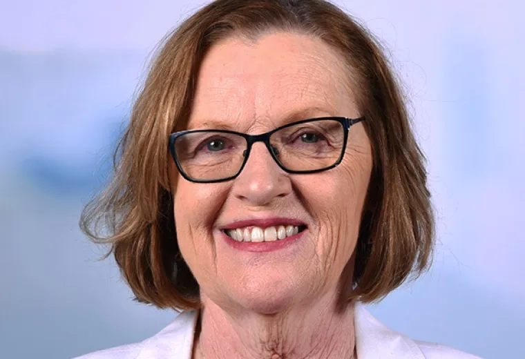 susan has a white jacket and dark pink lipstick she wears glasses