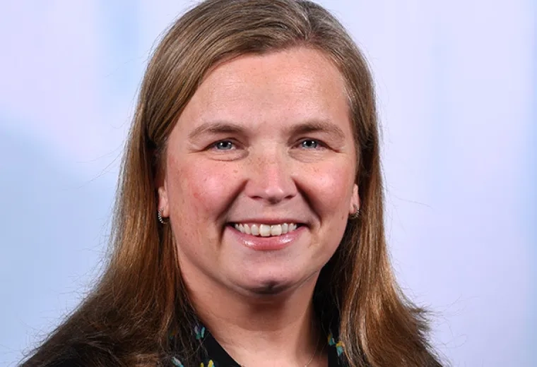 sara has light brown shoulder length hair parted on the side