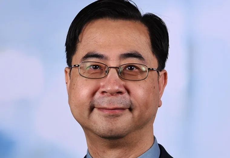 john wears oval glasses and a yellow tie