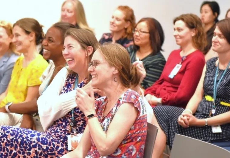 People smiling sitting in chairs