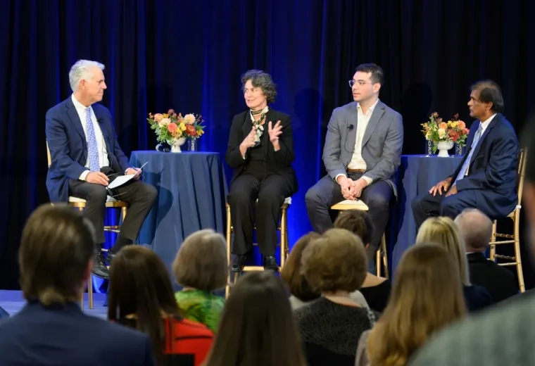 4 people speaking on a stage