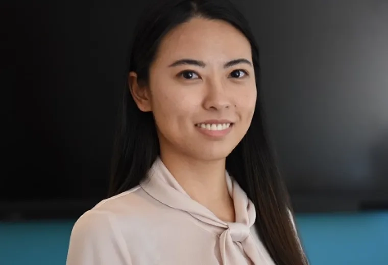 ziyi wears a beige shirt with a bow and has long straight dark hair