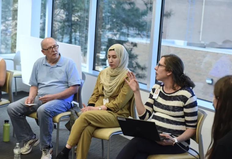 3 people sitting and talking