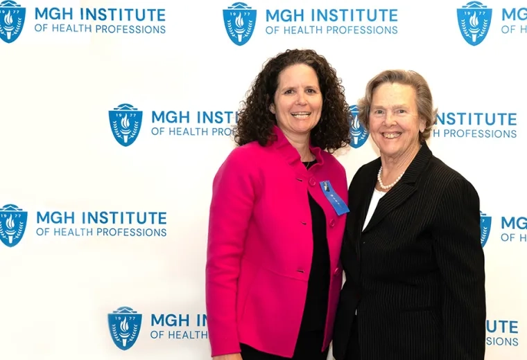 Two women standing and smiling