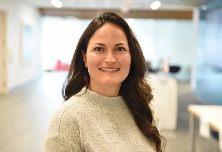 anya has a cream colored sweater and wavy brown hair past her shoulders