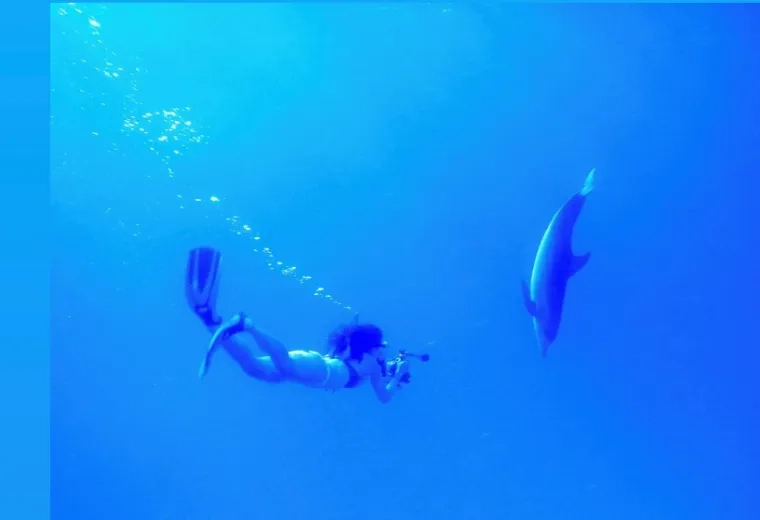 WOMAN DIVES WITH SHARK