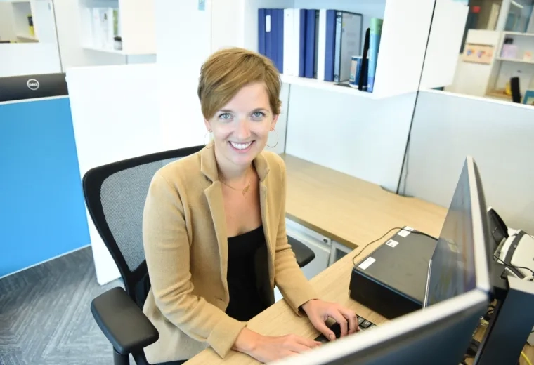 woman sitting at computer and smiling