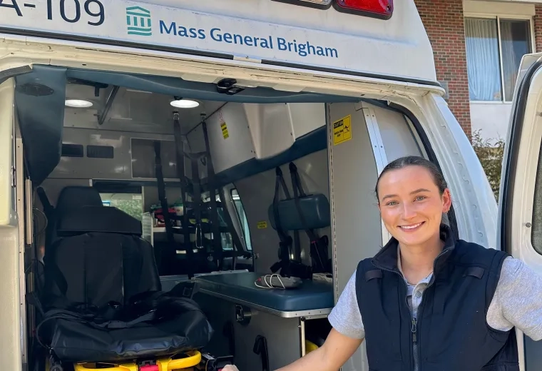 Woman standing with an ambulance