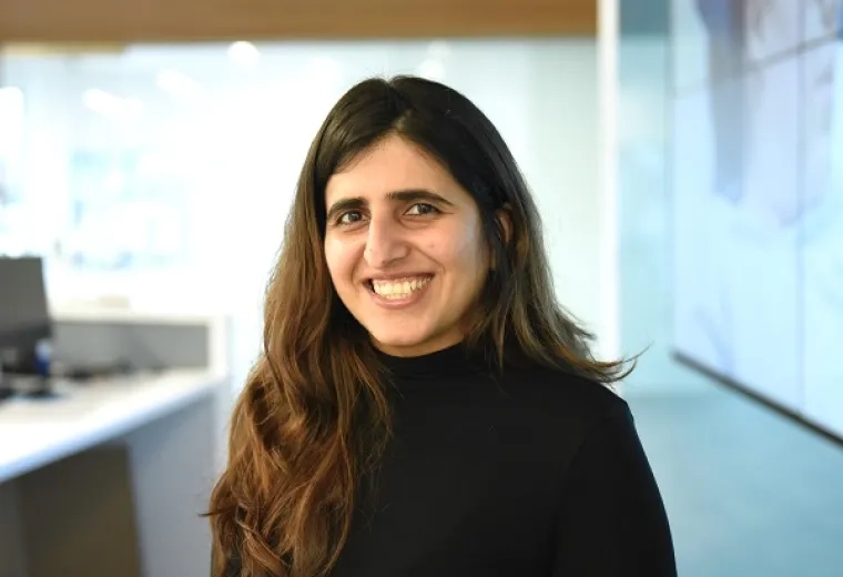 Pooja Jethani has long dark hair and is in a black shirt