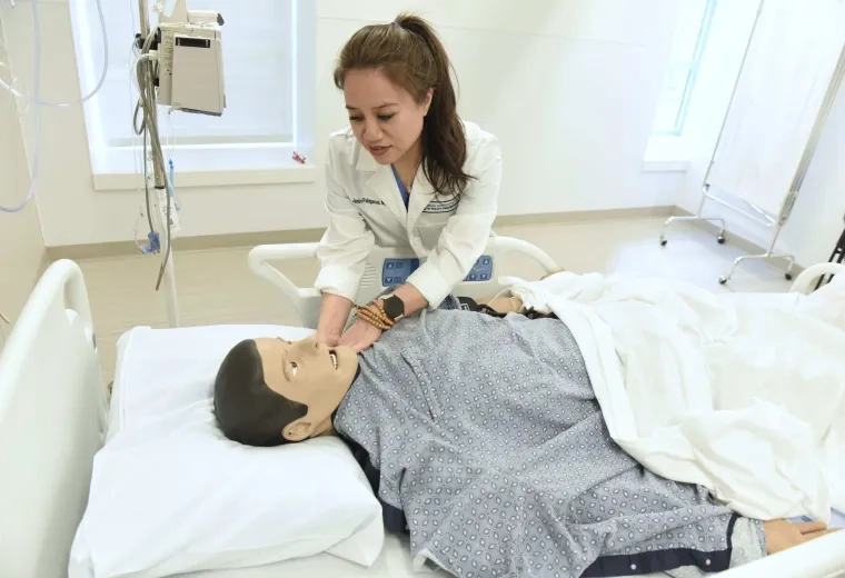 Woman working with a simulation manikin