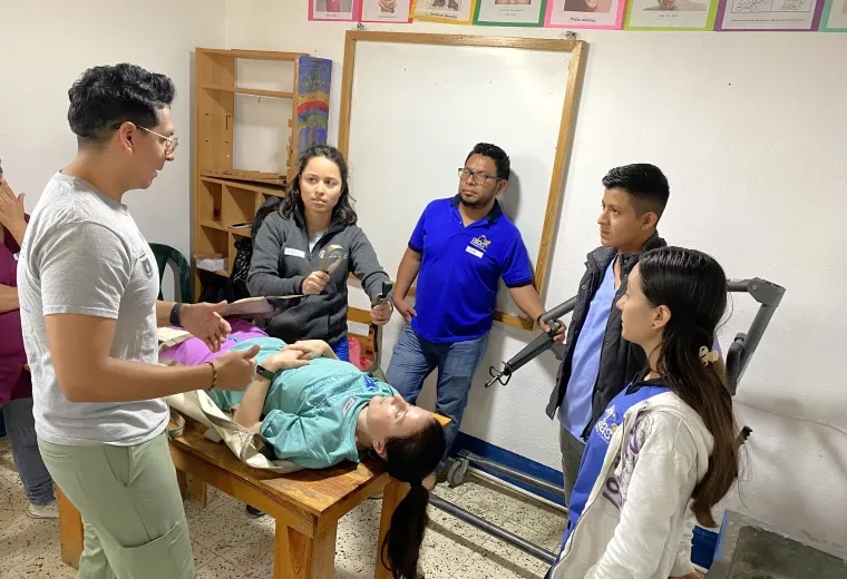 People being instructed on assistant a patient.