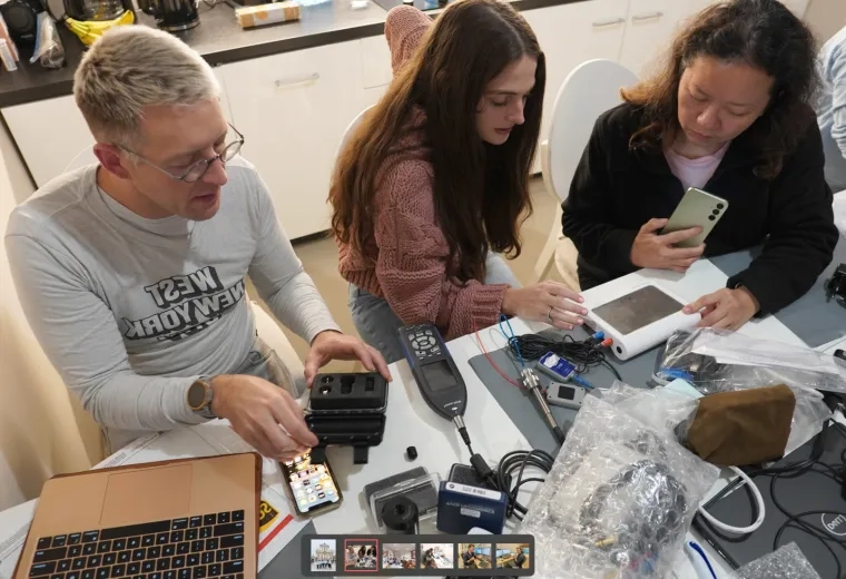 AuD students collaborating on audiology equipment setup during a hands-on learning session.