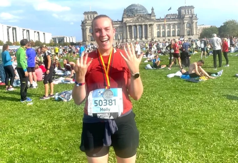 Woman smiles after completing a marathon.