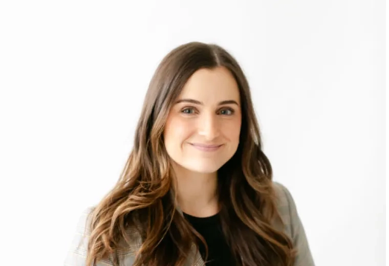 Brittany Palaski in black shirt and plaid grey blazer