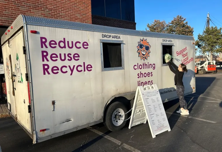 woman stands at textile drive truck
