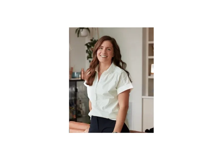 woman poses and smiles