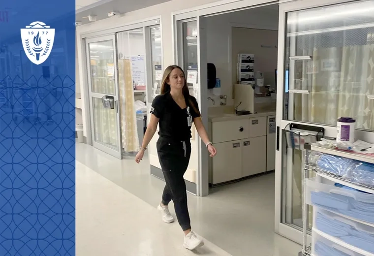 Nursing student at MGH IHP walking through clinical training facility during ABSN program rotation.