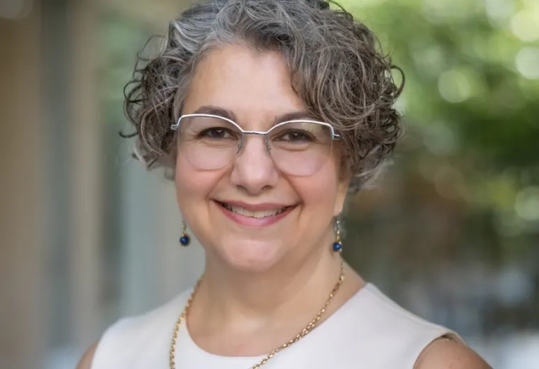 terry has silver rimmed glasses and curly grey hair