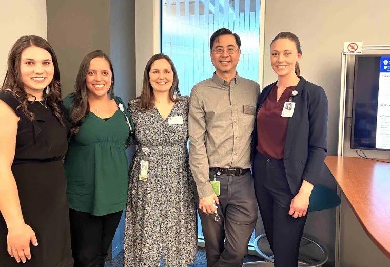 5 people standing and smiling