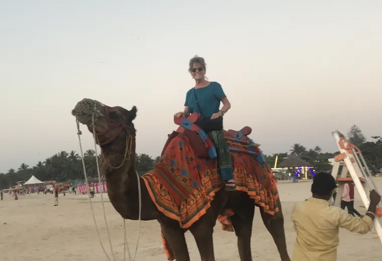 woman sits on a camel 