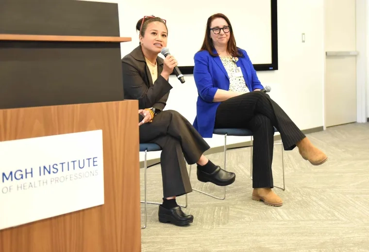 Two people talking on stage