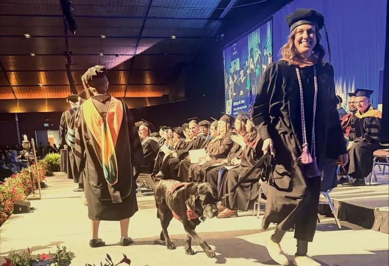 Woman and dog walk across stage