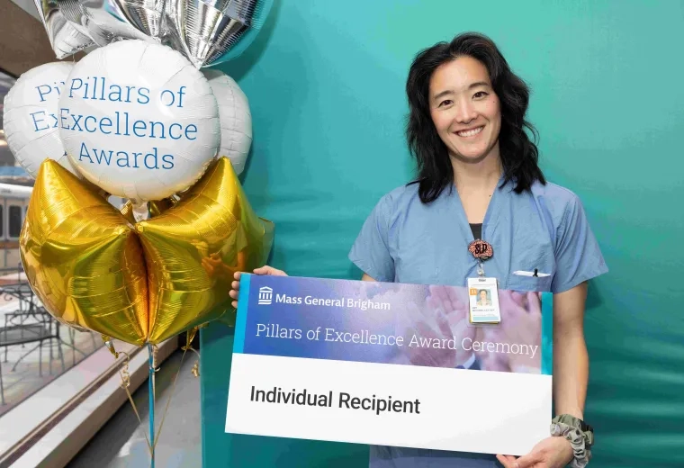 Woman in scrubs smiling